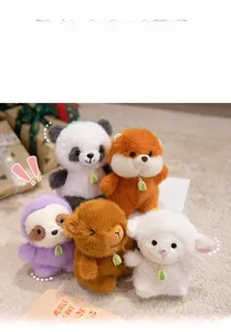 Close-up of fluffy animal plush keychains including panda and sloth with leaf pendants