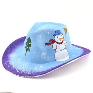 Detail of blue felt Christmas cowboy hat featuring snowman patterns and Merry Christmas text