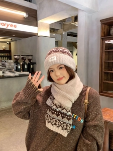 Close-up of Fair Isle knit hat and scarf set with wavy patterns in beige and coffee