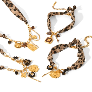 Golden chain bracelet set with leopard print fabric and mixed metal pendants