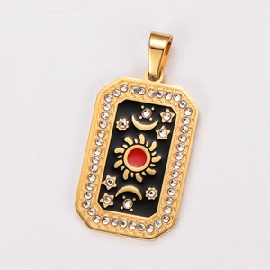 Close-up of gold tarot pendant with celestial sun and moon relief on black enamel