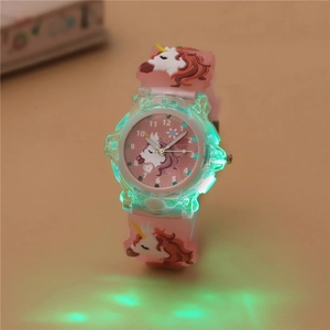 Macro shot of luminous pink unicorn watch with glowing green LED light effect for kids