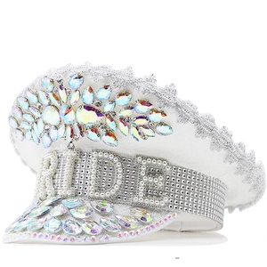 Detail of white sequin captain hat with iridescent gemstones and BRIDE rhinestone lettering