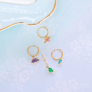 Dainty gold dinosaur hoop earrings with colorful zircon stones in purple, green, and blue