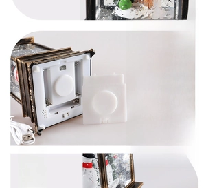 Détail de lanterne boule à neige de Noël montrant câble USB et compartiment à piles AAA