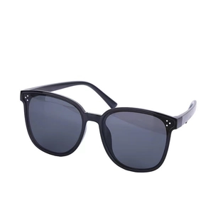 Classic large black frame sunglasses with three silver metal rivets and grey lenses