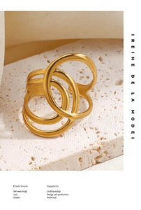 Detail of minimalist 18K gold plated multi-layer wrap ring on stone background