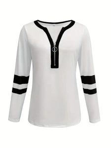 Detail of V-neck white sweatshirt featuring black ring zipper and striped sleeve cuffs