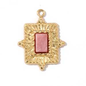 Detailed view of a vintage gold pendant featuring a rectangular pink crystal gemstone