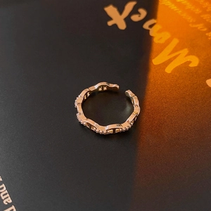 Macro shot of gold vintage ring featuring zircon pavé and unique hollow link structure