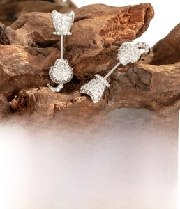 Detail of silver cat-shaped stud earring with cubic zirconia and titanium steel post