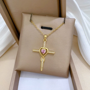 Elegant gold titanium steel cross necklace with a pink heart gemstone on silk
