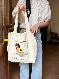 Minimalist cream canvas tote bag with dog embroidery and text for daily commute