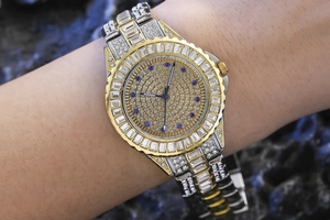 Close-up of luxury iced-out watch with crystal bezel and gold silver metal strap