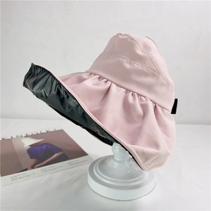 Detail of pink sun hat with black vinyl coating for UV protection and shell shape