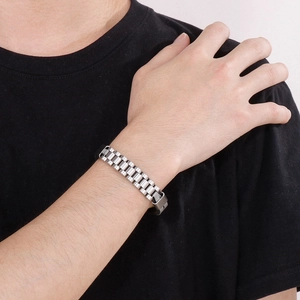 Silver titanium steel watch band style bracelet with braided leather on a male wrist