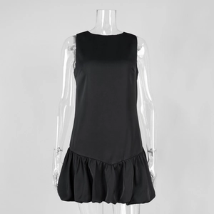 Detail of black sleeveless mini dress featuring a voluminous tiered ruffle hem and round neck