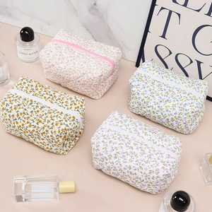 Floral print makeup bag set in pink blue yellow and purple with zipper closure