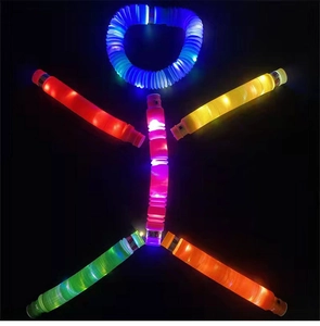 Glow-in-the-dark LED pop tubes arranged in a human shape against a black background