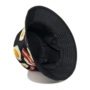 Detailed close-up of sunnyside egg and bacon print on a black outdoor sun bucket hat