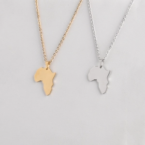 Detailed view of polished gold and silver African map pendants on slim O-chains