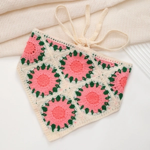 Detail of handmade crochet triangle headscarf with pink and green granny square patterns