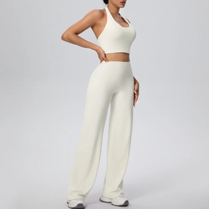 Detail of ivory white halter yoga bra and wide-leg trousers set in premium elastic fabric