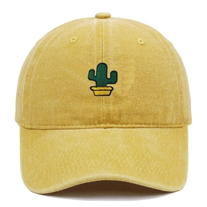 Close-up of green cactus embroidery on washed cotton canvas yellow baseball cap