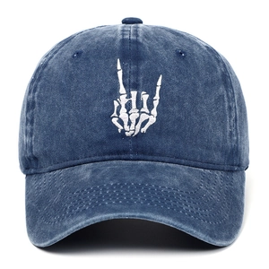 Detail of white skull hand embroidery on navy blue washed cotton baseball cap