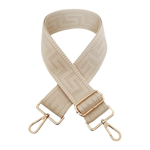 Adjustable beige jacquard shoulder strap with golden hooks and geometric pattern
