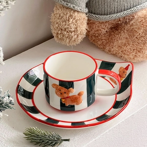 Hand-painted ceramic coffee cup and saucer set with brown teddy bear design and red trim