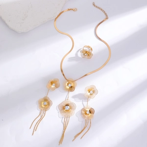Detailed view of hollow flower jewelry set with gold finish and zircon stones
