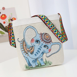 Beige canvas shoulder bag with blue elephant embroidery and colorful woven strap