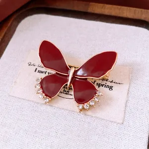 Vintage butterfly brooch in dark red enamel and gold finish with sparkling crystals