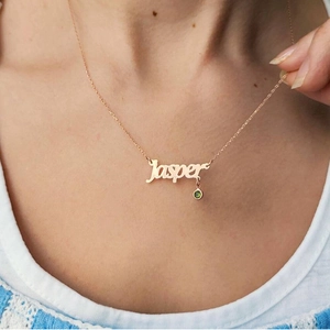Detailed shot of rose gold personalized Jasper name necklace with a green birthstone pendant