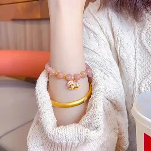 Pink sunstone beaded bracelet with gold elephant charm and matching gold bangle