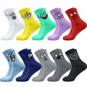 Flat lay of colorful cotton crew socks featuring 10 assorted cartoon smile face patterns