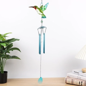 Detail of colorful glass hummingbird wind chime with four blue metal tubes and crystal pendant