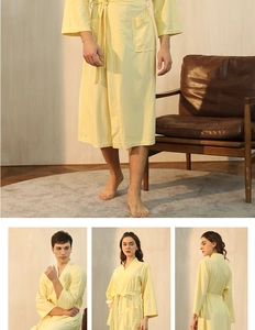 Detail of light yellow waffle knit bathrobe showing absorbent fabric and side pocket