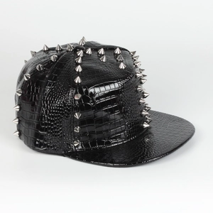 Close-up of black crocodile texture leather baseball cap with silver metal punk rivets