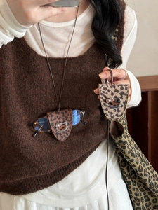 Detail of leopard print leather glasses case necklace with cartoon cat metal buckle detail