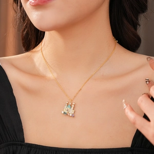 Close-up of gold-plated castle necklace with colorful zircon stones on model's neck