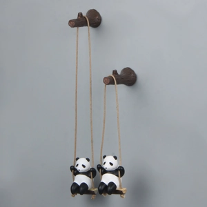 Detailed view of creative panda swing hanging figurines with realistic tree branch hooks
