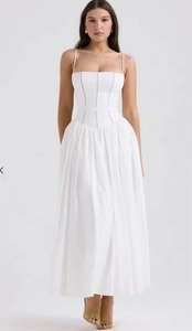 Detailed view of a white lace-trimmed maxi dress with a structured corset waist design