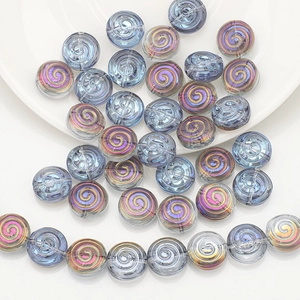 Detailed macro of iridescent spiral glass beads for DIY jewelry and crafts