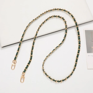 Detail of gold metal chain woven with dark green leather and swivel lobster clasps