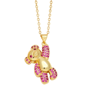 Golden teddy bear pendant necklace featuring rose pink crystals and polished finish