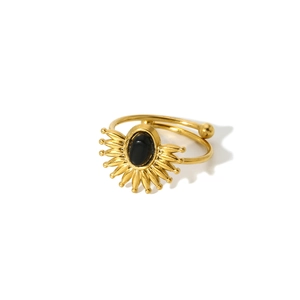 Detailed macro view of 18k gold-plated sunburst ring with black gemstone setting
