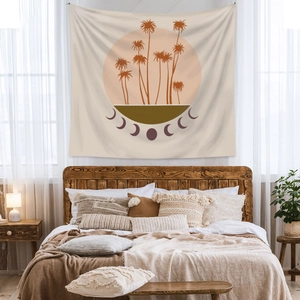 Detail showing bohemian tapestry with palm tree and moon phases in warm earth tones
