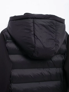 Macro shot of black puffer jacket featuring horizontal quilting and a cozy hood design